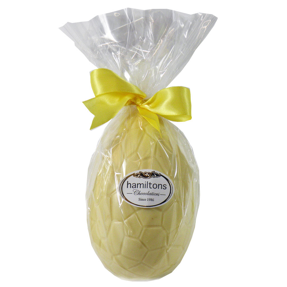 Small Whole White Easter Egg Filled With An Assortment Of White Chocolates