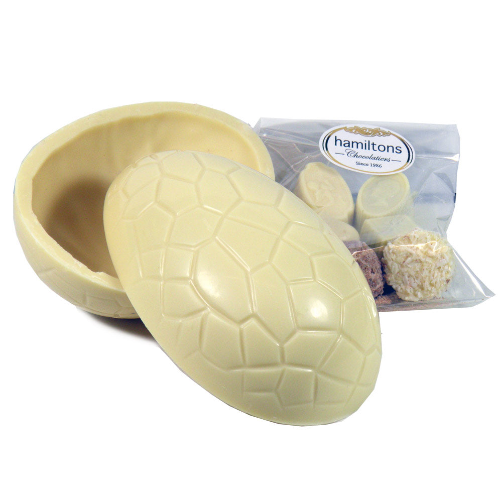 Small Whole White Easter Egg Filled With An Assortment Of White Chocolates